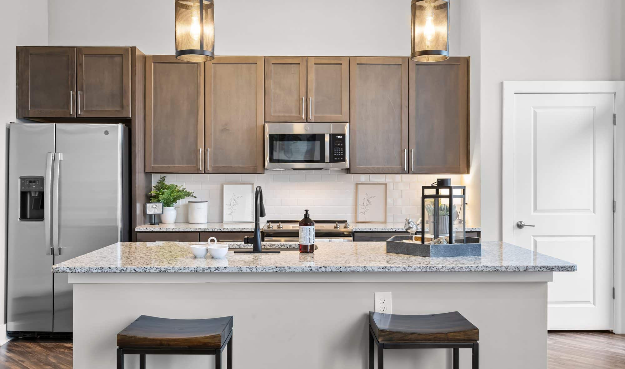 Modern kitchen with stainless steel appliances at .408 Jackson Apartments
